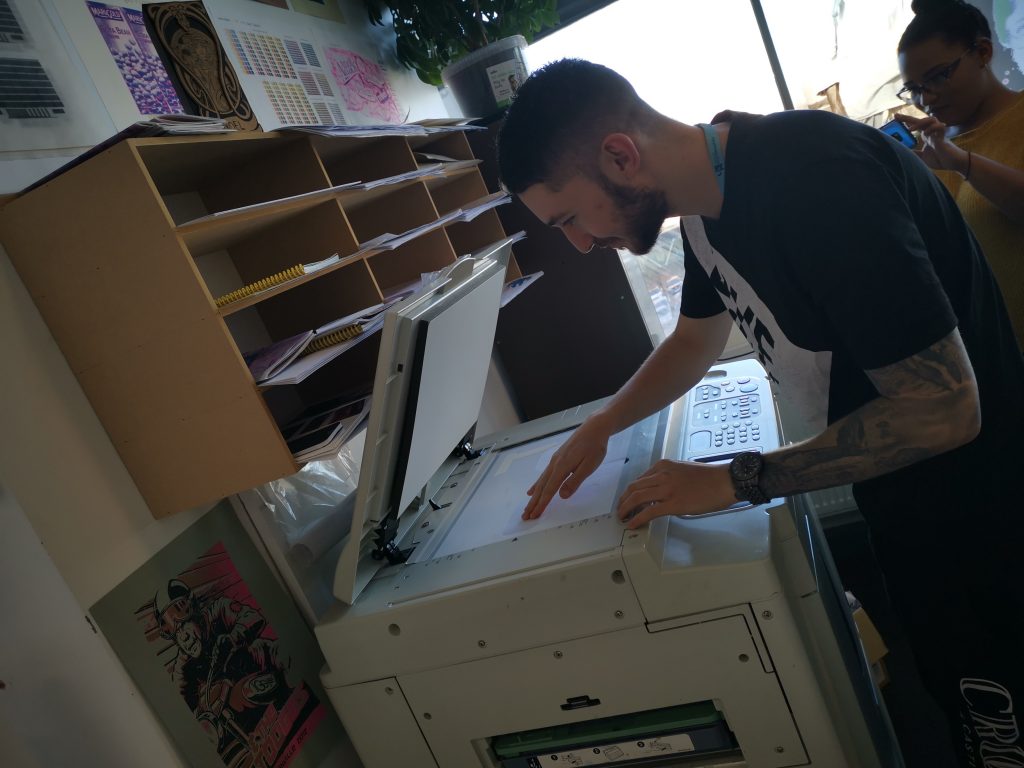 First-year GD Student, Sean sets up artwork at the Risograph printer