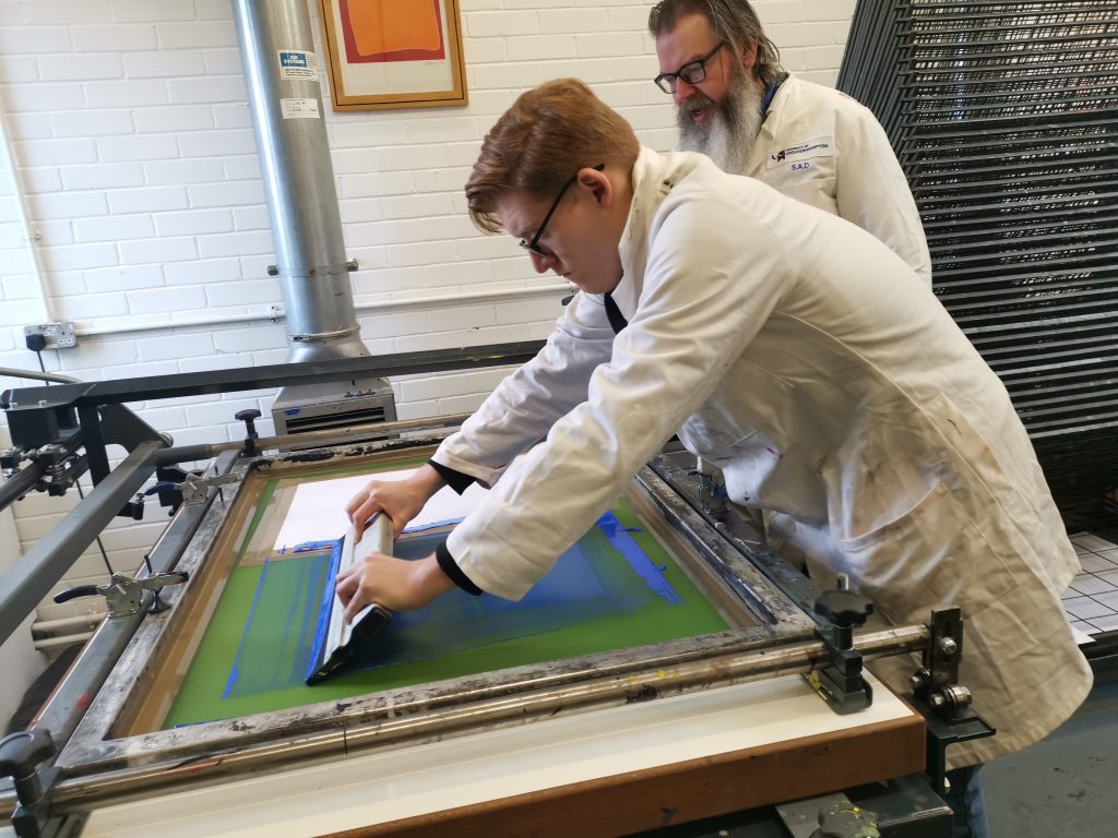 First-year John, under guidance from principal technician Martin working on typographic silk screen prints