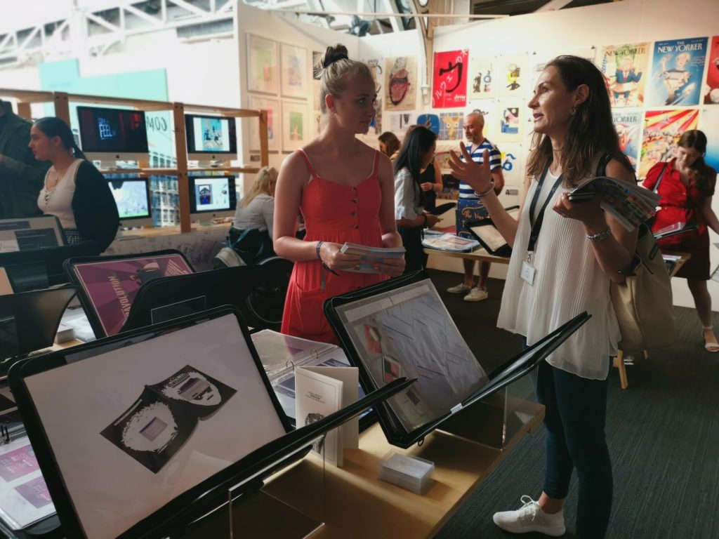 First-class graduate Lauren discusses employment opportunities with an industry contact at the New Designers exhibition in London 
