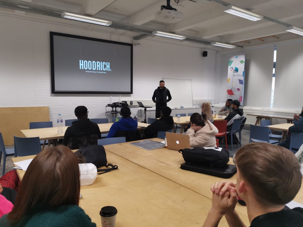 Alumni Martin Garbett, creative director for Hoodrich apparel, pitches a job opportunity to students in the WLV GD Baseroom