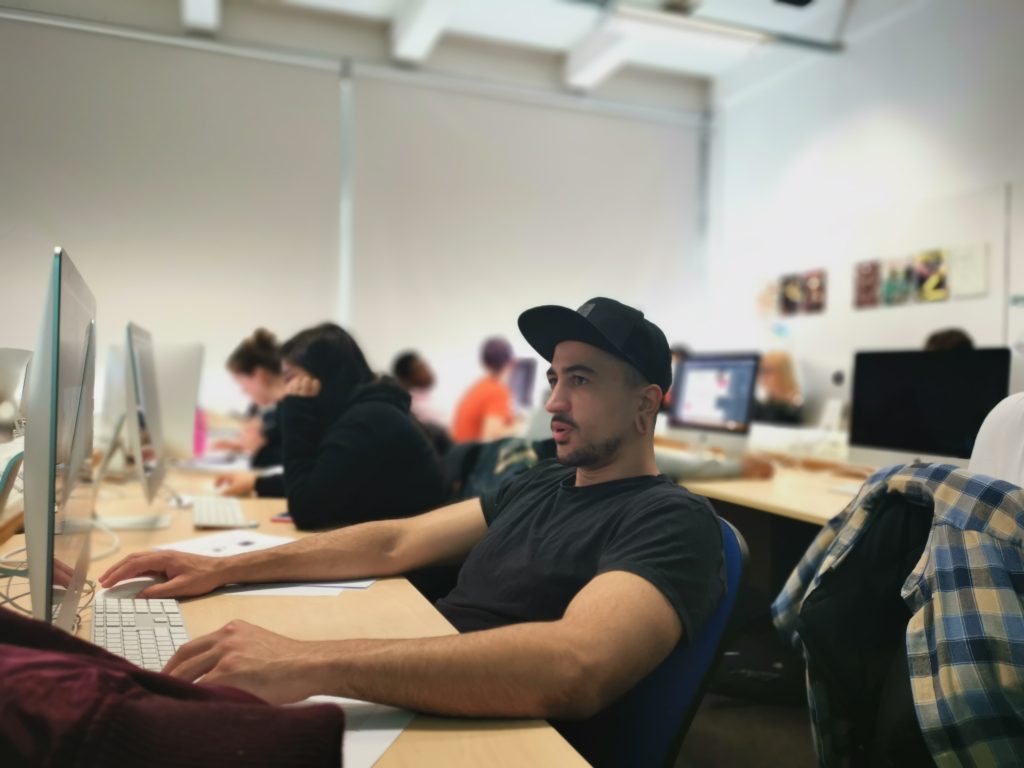 First-year student Jed focusing on a digital design project in the WLV GD Mac Lab